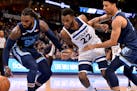 Memphis forward Jae Crowder (99), Timberwolves guard Andrew Wiggins (22), and Grizzlies forward Brandon Clarke chase a loose ball in the first half