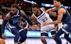 Memphis forward Jae Crowder (99), Timberwolves guard Andrew Wiggins (22), and Grizzlies forward Brandon Clarke chase a loose ball in the first half