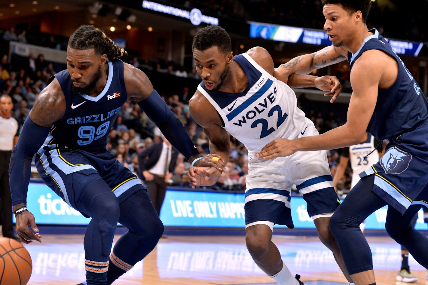 Memphis forward Jae Crowder (99), Timberwolves guard Andrew Wiggins (22), and Grizzlies forward Brandon Clarke chase a loose ball in the first half