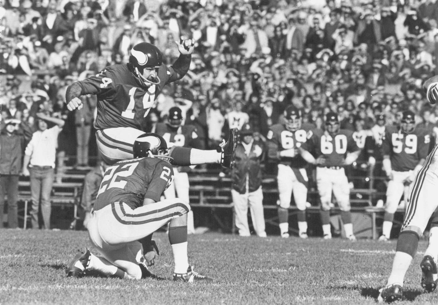 A common sight for Vikings fans in the 1960s and 1970s was Fred Cox kicking out of the hold of safety Paul Krause.