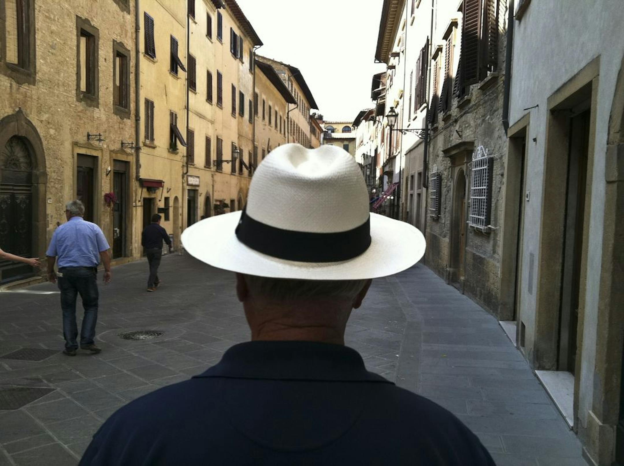 This street scene was captured using the iPhone in San Gimignano, Italy. In some ways this man's straw hat is like a still life framed by the main concourse. The fact that it's placed at the vanishing point in the image draws your eye all the more to it.