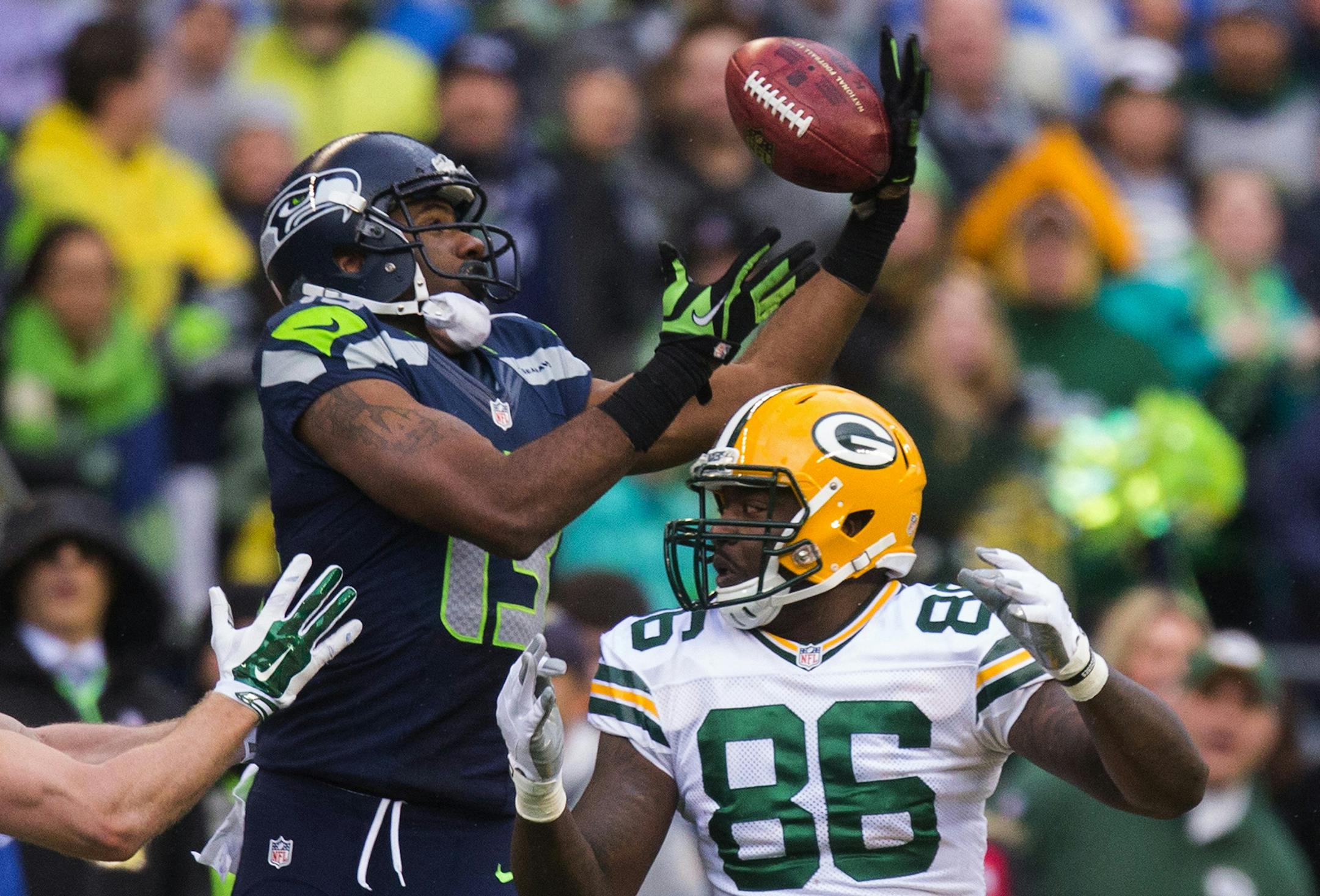 After Seattle Seahawks kicker Steven Hauschka kicked an onside kick, Green Bay Packers tight end Brandon Bostick had his hands on the ball but couldn't keep it and Seahawks wide receiver Chris Matthews recovered the ball during the fourth quarter on Sunday, Jan. 18, 2015, at CenturyLink Field in Seattle. (Dean Rutz/Seattle Times/TNS)