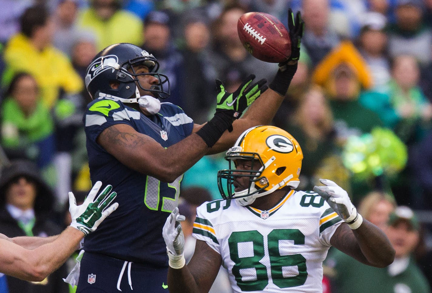 After Seattle Seahawks kicker Steven Hauschka kicked an onside kick, Green Bay Packers tight end Brandon Bostick had his hands on the ball but couldn't keep it and Seahawks wide receiver Chris Matthews recovered the ball during the fourth quarter on Sunday, Jan. 18, 2015, at CenturyLink Field in Seattle. (Dean Rutz/Seattle Times/TNS)