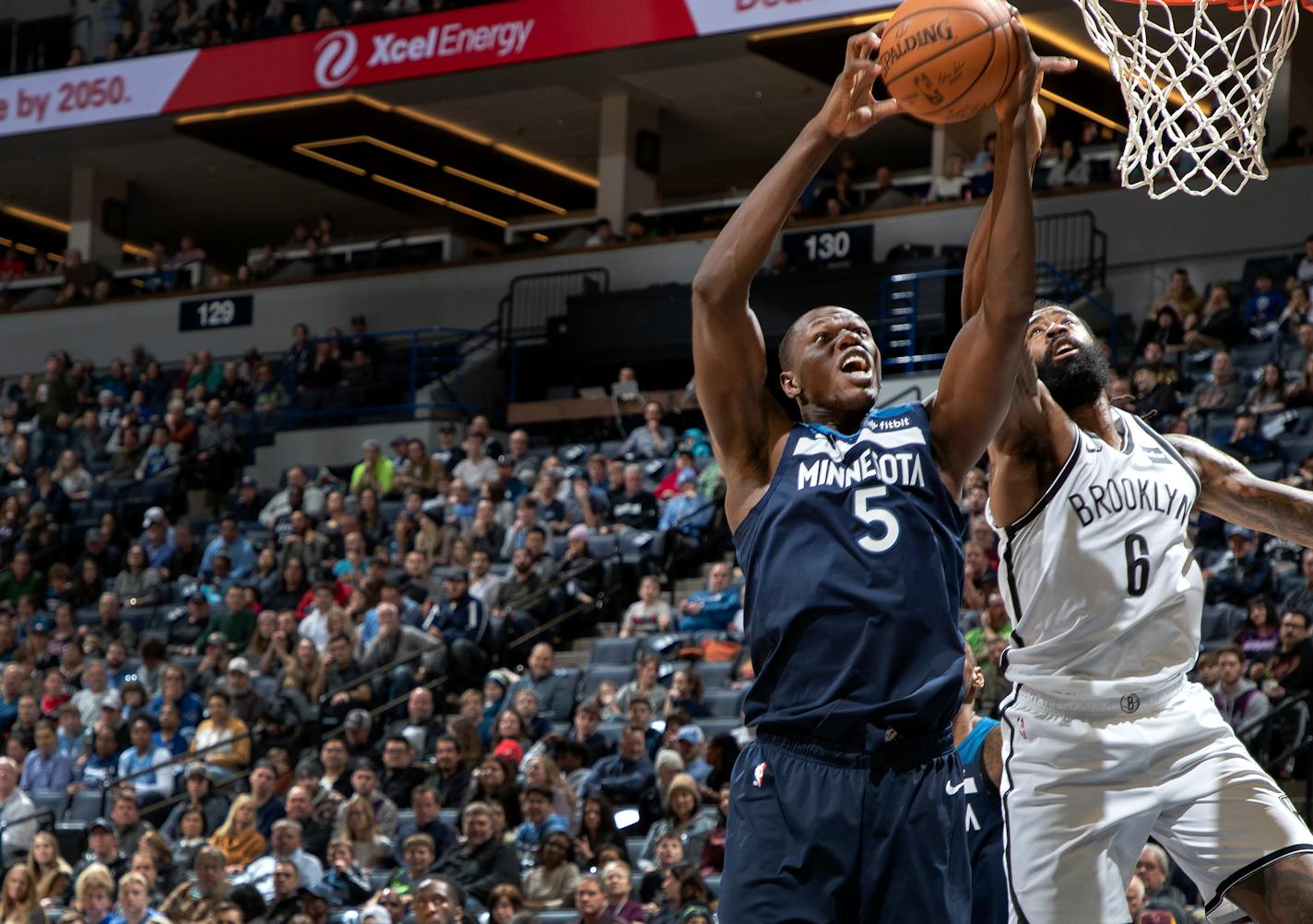 The Wolves' Gorgui Dieng (5) and the Nets' DeAndre Jordan battled for a rebound in the second quarter Monday. Dieng finished with 20 rebounds.