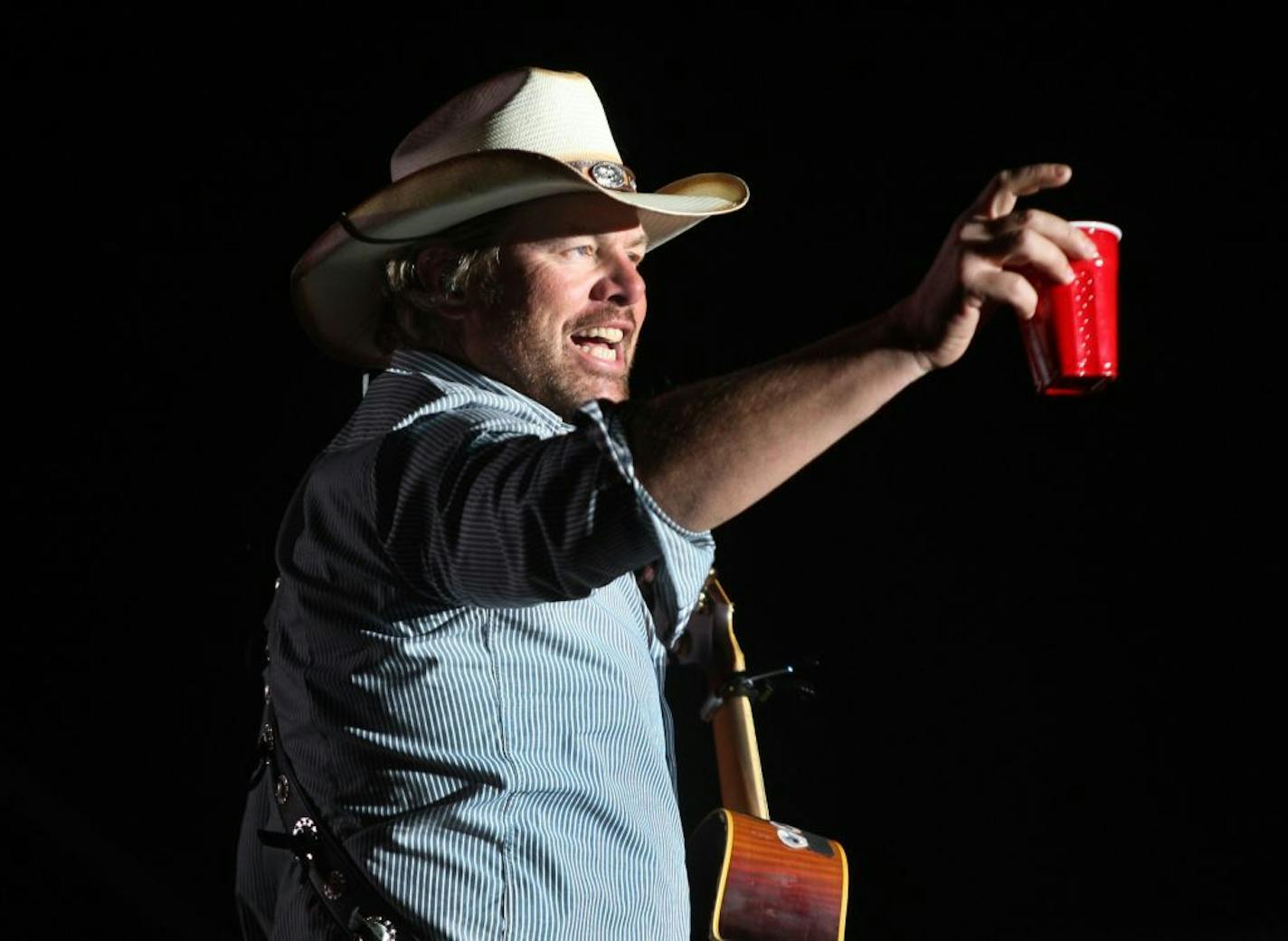 Toby Keith toasts his fans with a red Solo Cup, the name of one of his hit songs, on April 26, 2013 during the first day of the Stagecoach Country Music Festival.