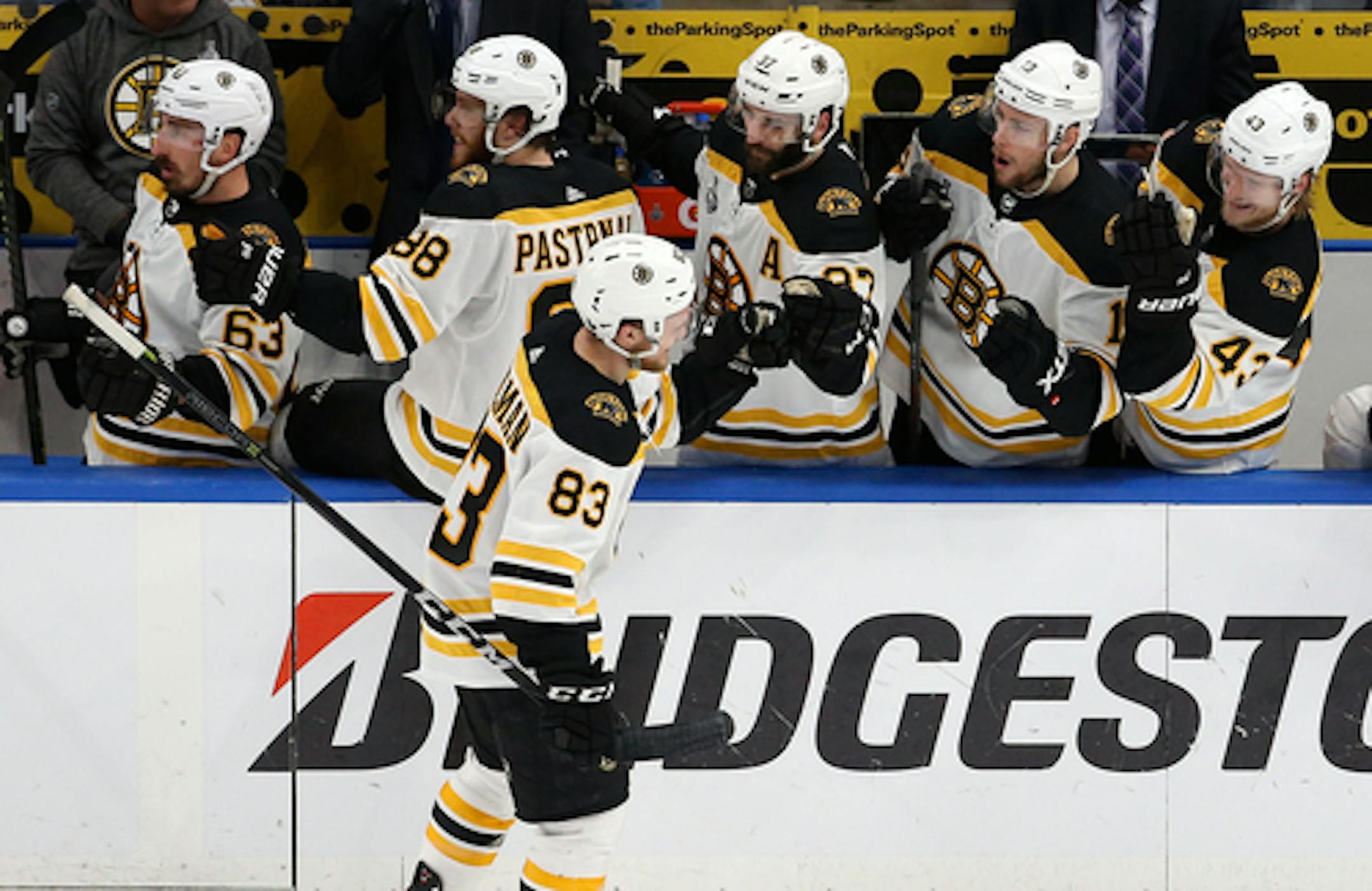 Boston Bruins center Karson Kuhlman (83) is congratulated after scoring a goal against the St. Louis Blues during the third period of Game 6 of the NHL hockey Stanley Cup Final Sunday, June 9, 2019, in St. Louis. (AP Photo/Scott Kane)