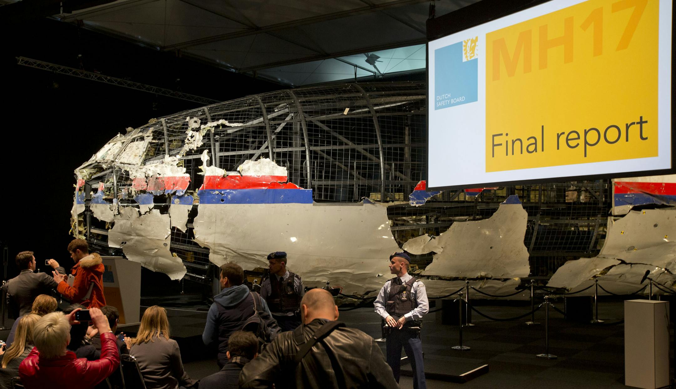 Part of the reconstructed Malaysia Airlines Flight 17 plane is seen prior to the presentation of the Dutch Safety Board presents the board’s final report into what caused Malaysia Airlines Flight 17 to break up high over Eastern Ukraine last year, killing all 298 people on board, during a press conference in Gilze-Rijen, central Netherlands, Tuesday, Oct. 13, 2015. (AP Photo/Peter Dejong)