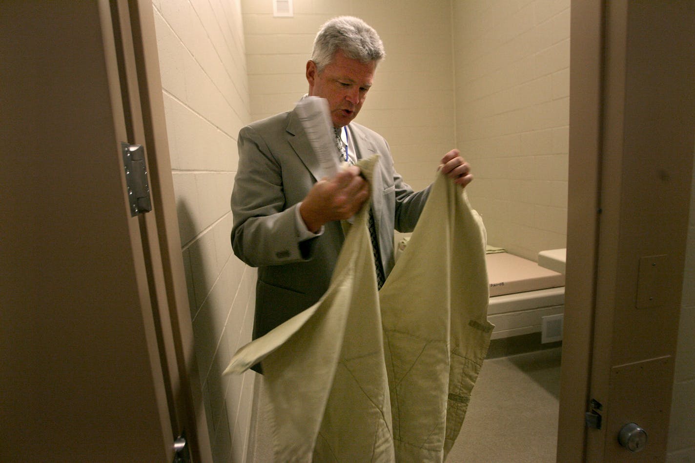 Warden John King showed a suicide-prevention gown. In the new unit guards can electronically monitor inmates' cells, lock and unlock doors, control water flow and even spray chemical irritants into cells.