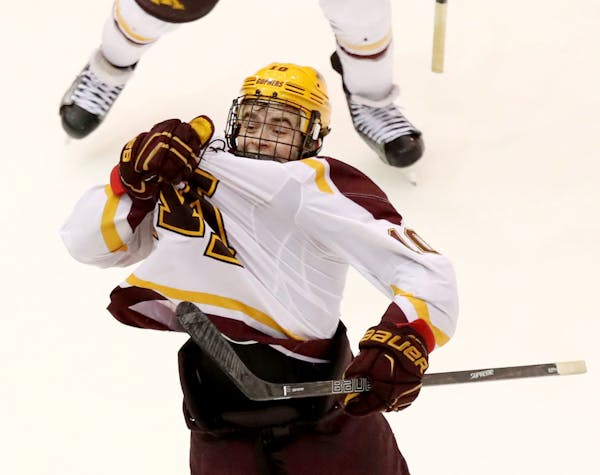 Minnesota's Brent Gates (10) pulls on the M of his jersey after tying the game during the third period against North Dakota on Nov. 4