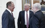 U.S. President Donald Trump meets with Russian Foreign Minister Sergey Lavrov, left, next to Russian Ambassador to the U.S. Sergei Kislyak at the Whit