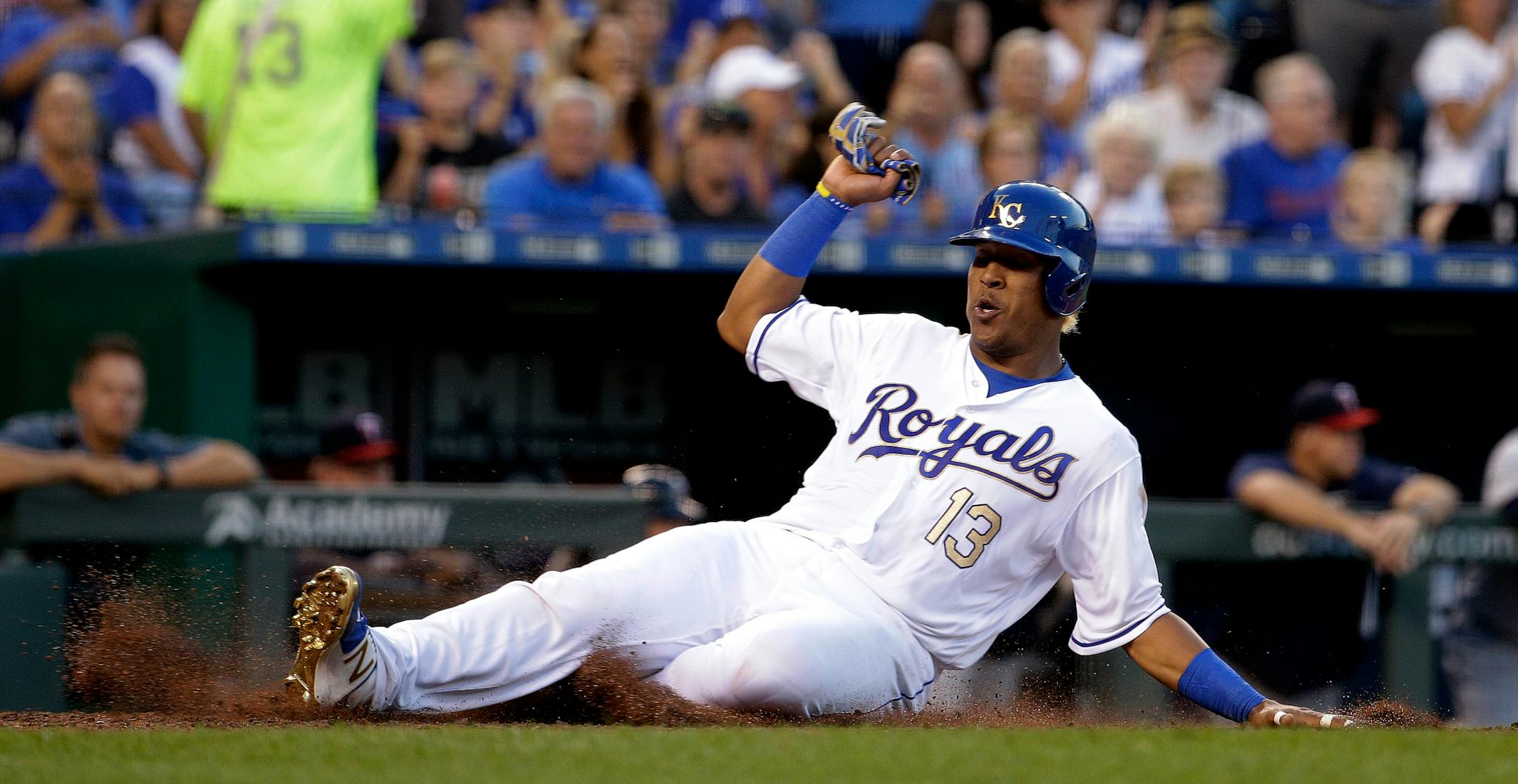 Kansas City Royals' Salvador Perez slides home to score on a single by Alcides Escobar during the fourth inning of a baseball game against the Minnesota Twins, Friday, June 30, 2017, in Kansas City, Mo. (AP Photo/Charlie Riedel)
