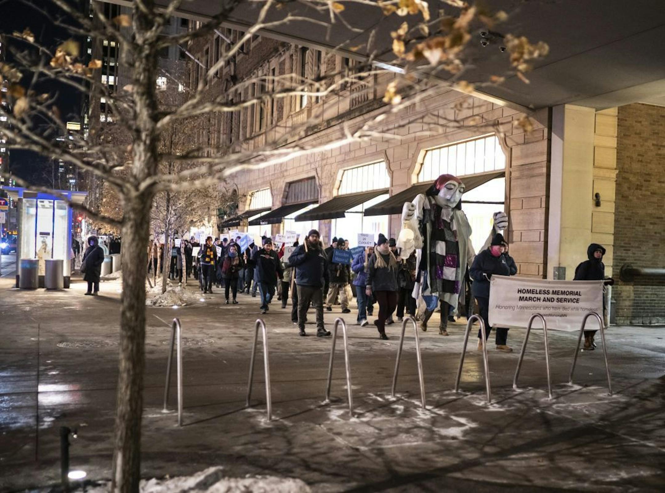 Several hundred people marched in the silent Homeless Memorial March carrying signs that recognized the 190 homeless, previously homeless and advocates for the homeless that died in 2019 on Thursday, December 19, 2019 through downtown Minneapolis, Minn.