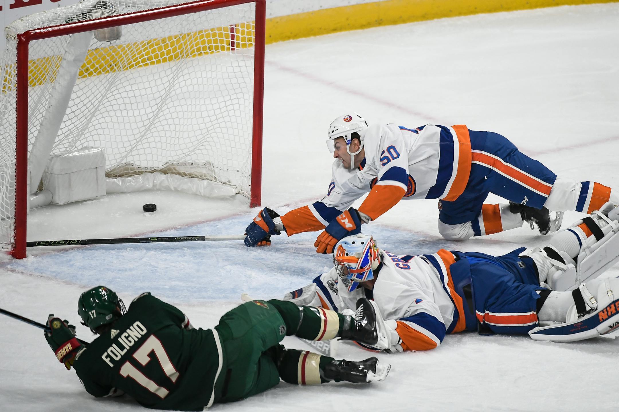 New York Islanders defenseman Adam Pelech (50) was unable to stop the puck as Minnesota Wild left wing Marcus Foligno (17) scored a goal on New York Islanders goalie Thomas Greiss (1) in the first period. ] AARON LAVINSKY ï aaron.lavinsky@startribune.com The Minnesota Wild played the New York Islander on Thursday, Oct. 26, 2017 at Xcel Energy Center in St. Paul, Minn.