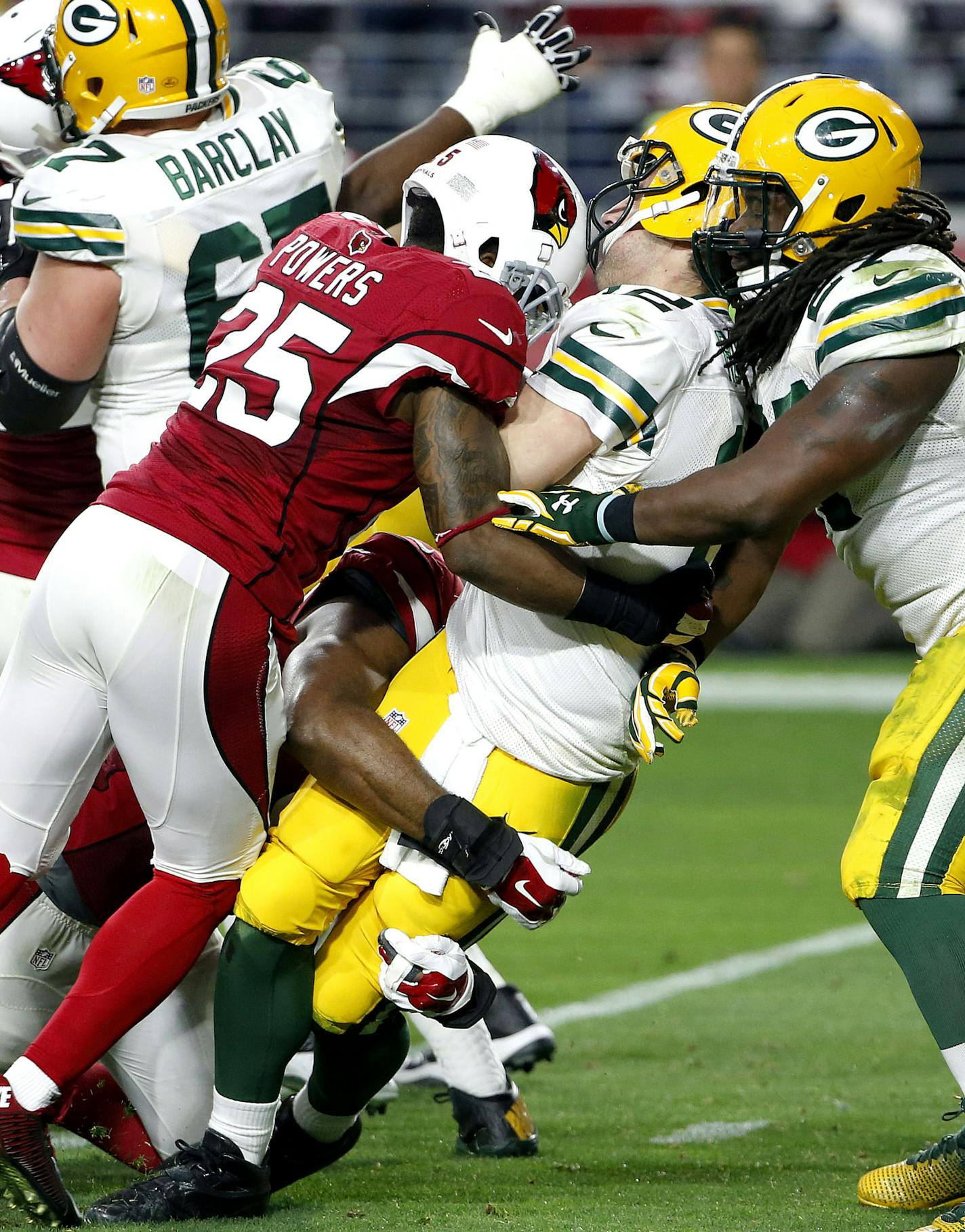 Green Bay Packers quarterback Aaron Rodgers (12) is sacked by Arizona Cardinals cornerback Jerraud Powers (25) during the second half of an NFL football game, Sunday, Dec. 27, 2015, in Glendale, Ariz. (AP Photo/Ross D. Franklin)