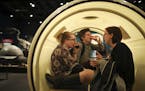 Alexis Arnold, Stephen Gray, and Annie Fridlund sipped their drinks and visited inside a 560 gallon plastic drum meant to represent the size of a dino