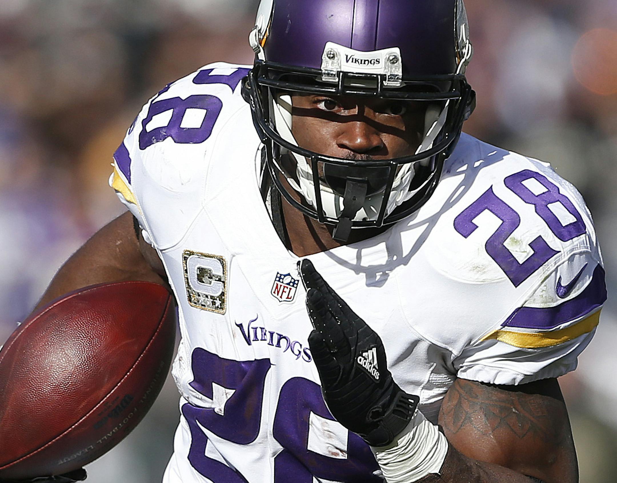 Minnesota Vikings running back Adrian Peterson (28) runs against the Oakland Raiders during the first half of an NFL football game in Oakland, Calif., Sunday, Nov. 15, 2015. (AP Photo/Beck Diefenbach)