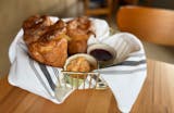 A basket of popovers with compound butter.