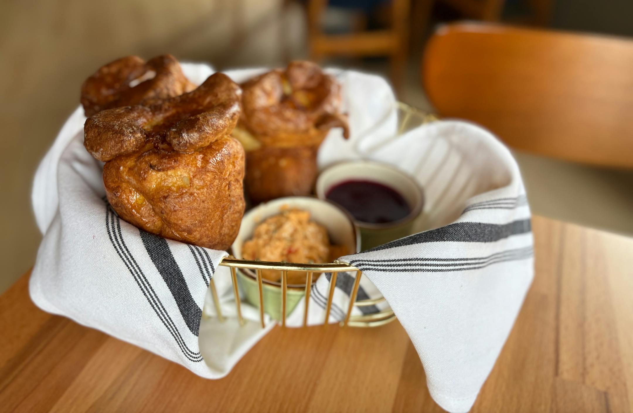 A basket of popovers with compound butter.