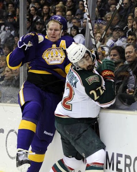 Wild right wing Cal Clutterbuck (right) gets hit by Trevor Gillies