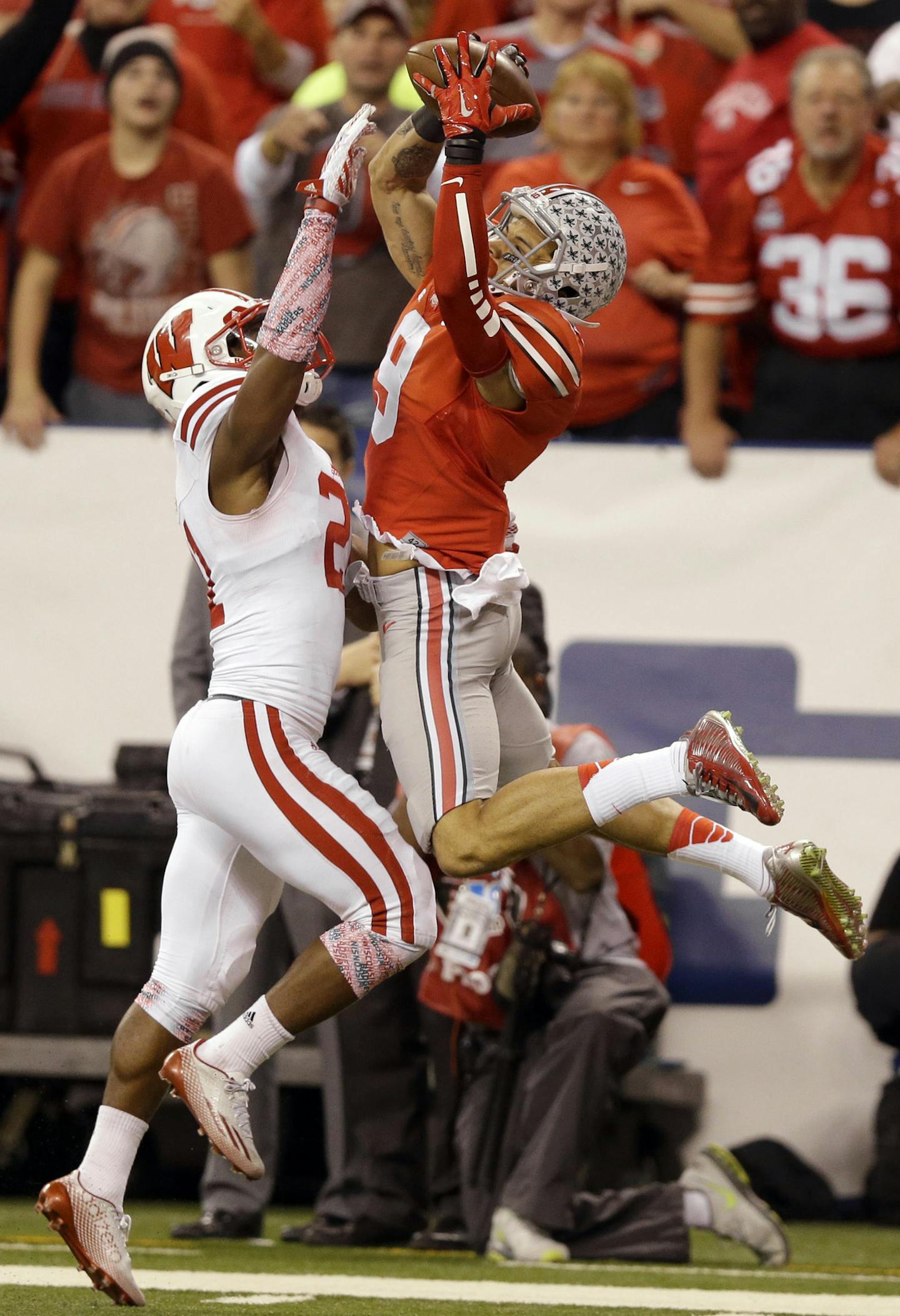 Ohio State wide receiver Devin Smith, right, catches a touchdown pass as Wisconsin cornerback Peniel Jean defends during the second half of the Big Ten Conference championship NCAA college football game Saturday, Dec. 6, 2014, in Indianapolis. (AP Photo/Michael Conroy)