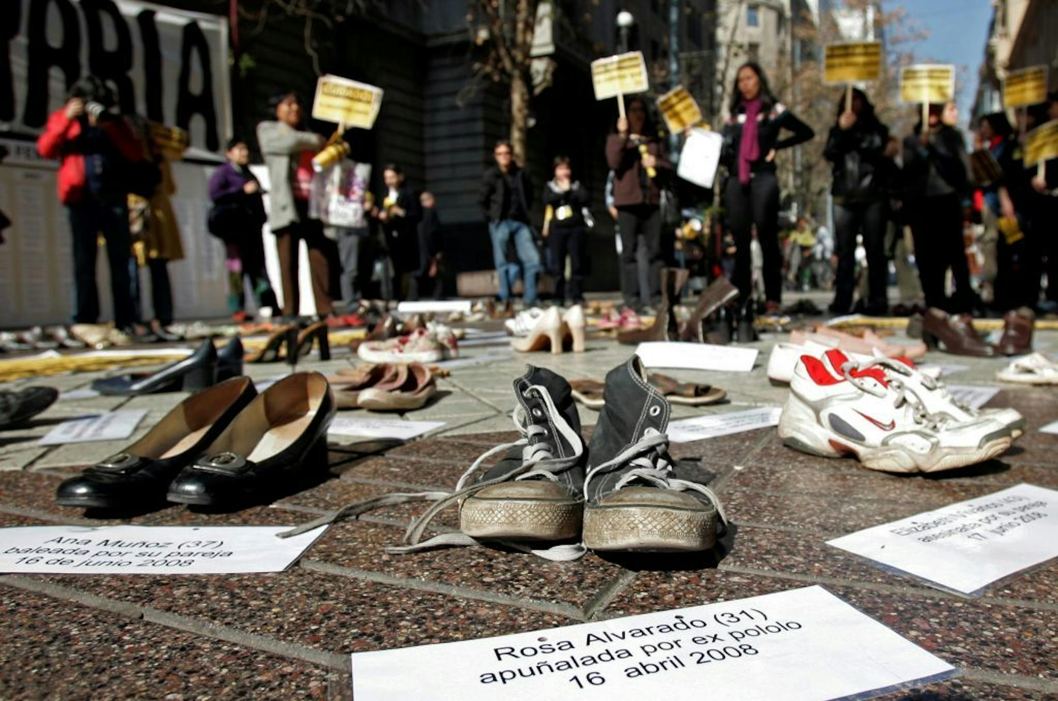 In this Thursday, July 30, 2009 file photo, shoes representing female victims of violence are displayed by protesters from the Chilean Network Against Domestic and Sexual Violence in Santiago. The sign at bottom reads: "Rosa Alvarado, 31, stabbed by ex-boyfriend, 16 April 2008."