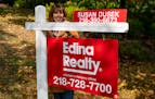 In this September 2020 file photo, Susan Dusek, a realtor for Edina Realty, posed for a portrait in front of a house for sale in the Congdon Park neig