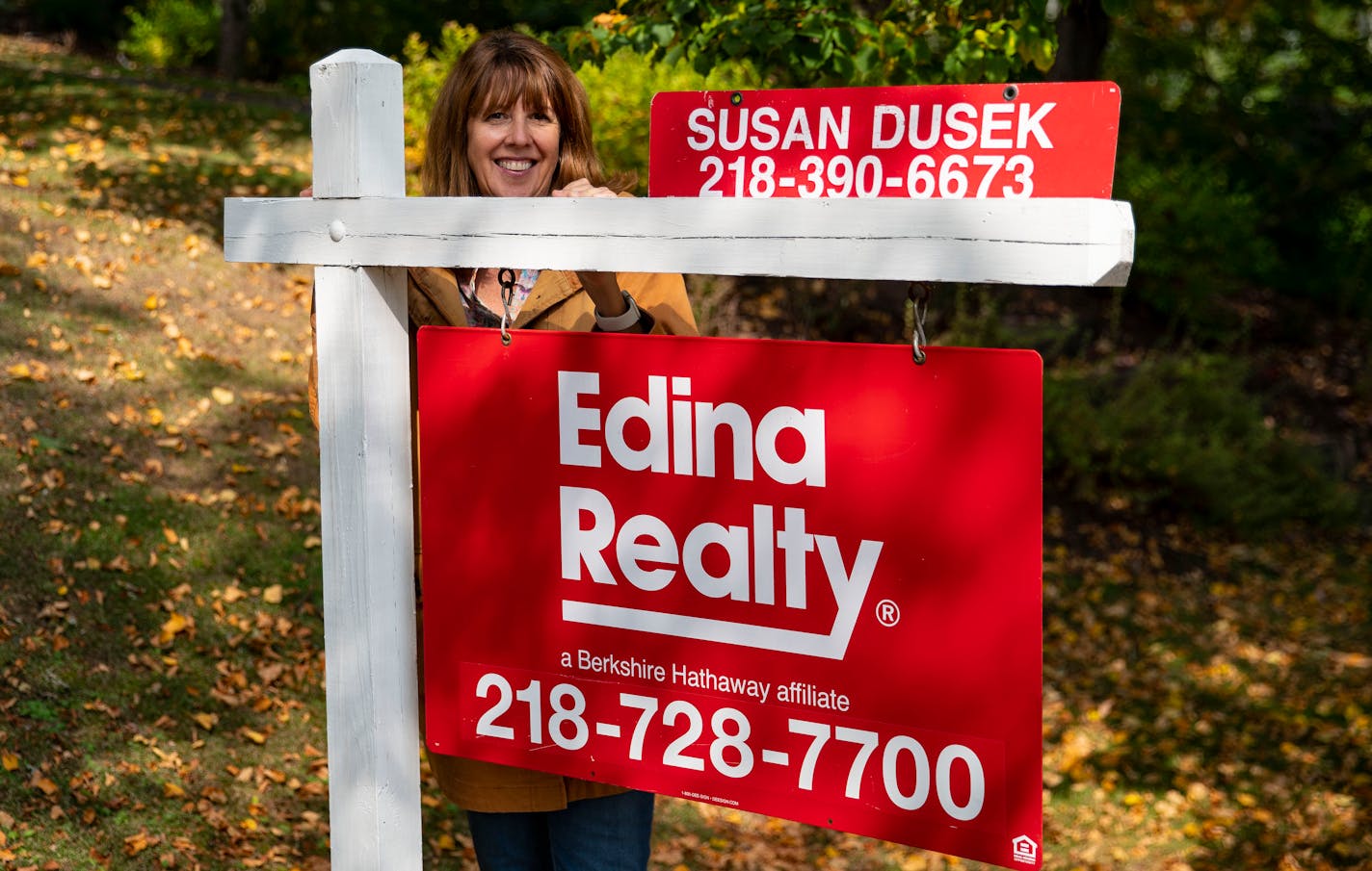 In this September 2020 file photo, Susan Dusek, a realtor for Edina Realty, posed for a portrait in front of a house for sale in the Congdon Park neighborhood in Duluth.