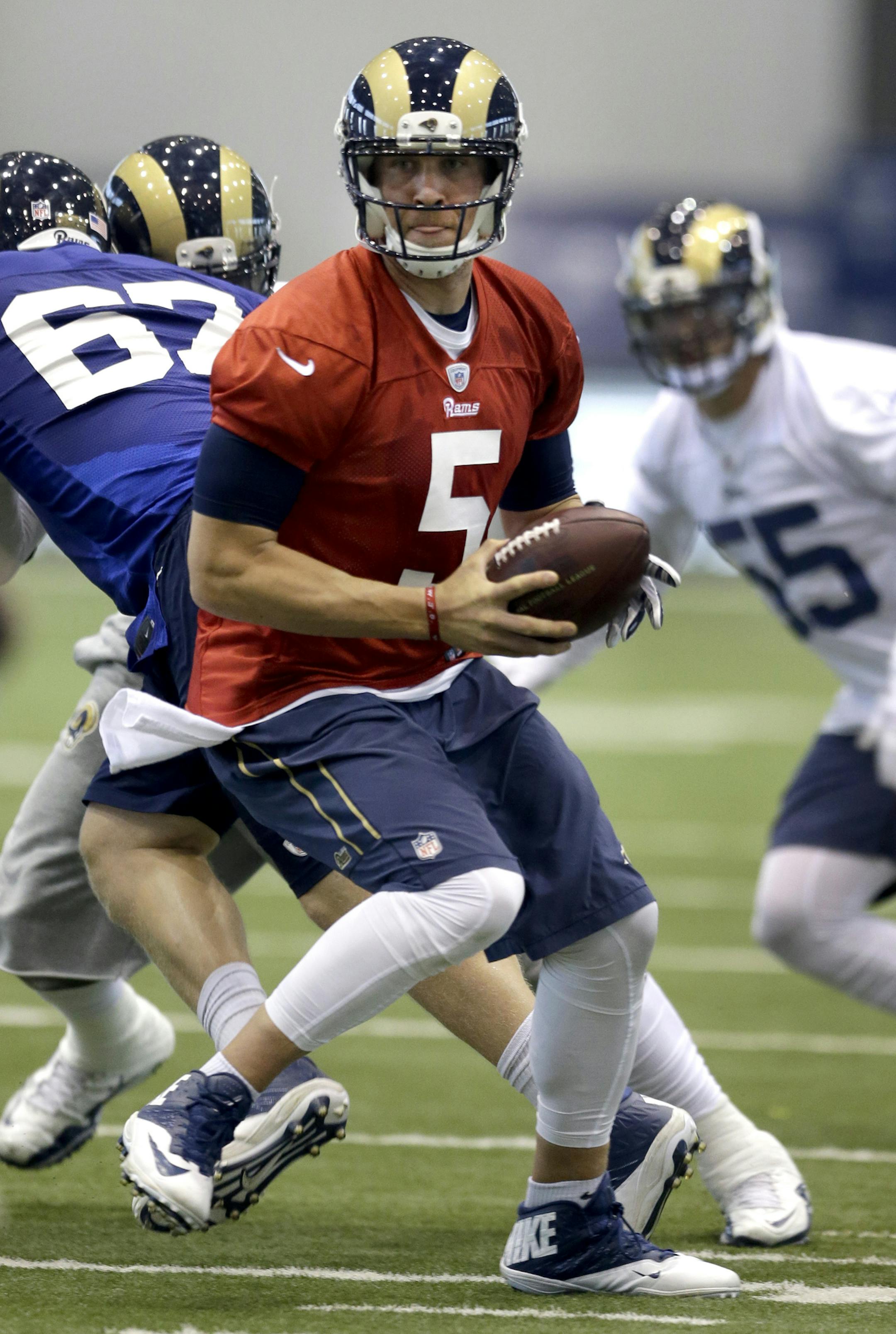 St. Louis Rams quarterback Nick Foles drops back to pass during an NFL football organized team activity, Thursday, June 4, 2015, in St. Louis. (AP Photo/Jeff Roberson) ORG XMIT: MOJR106