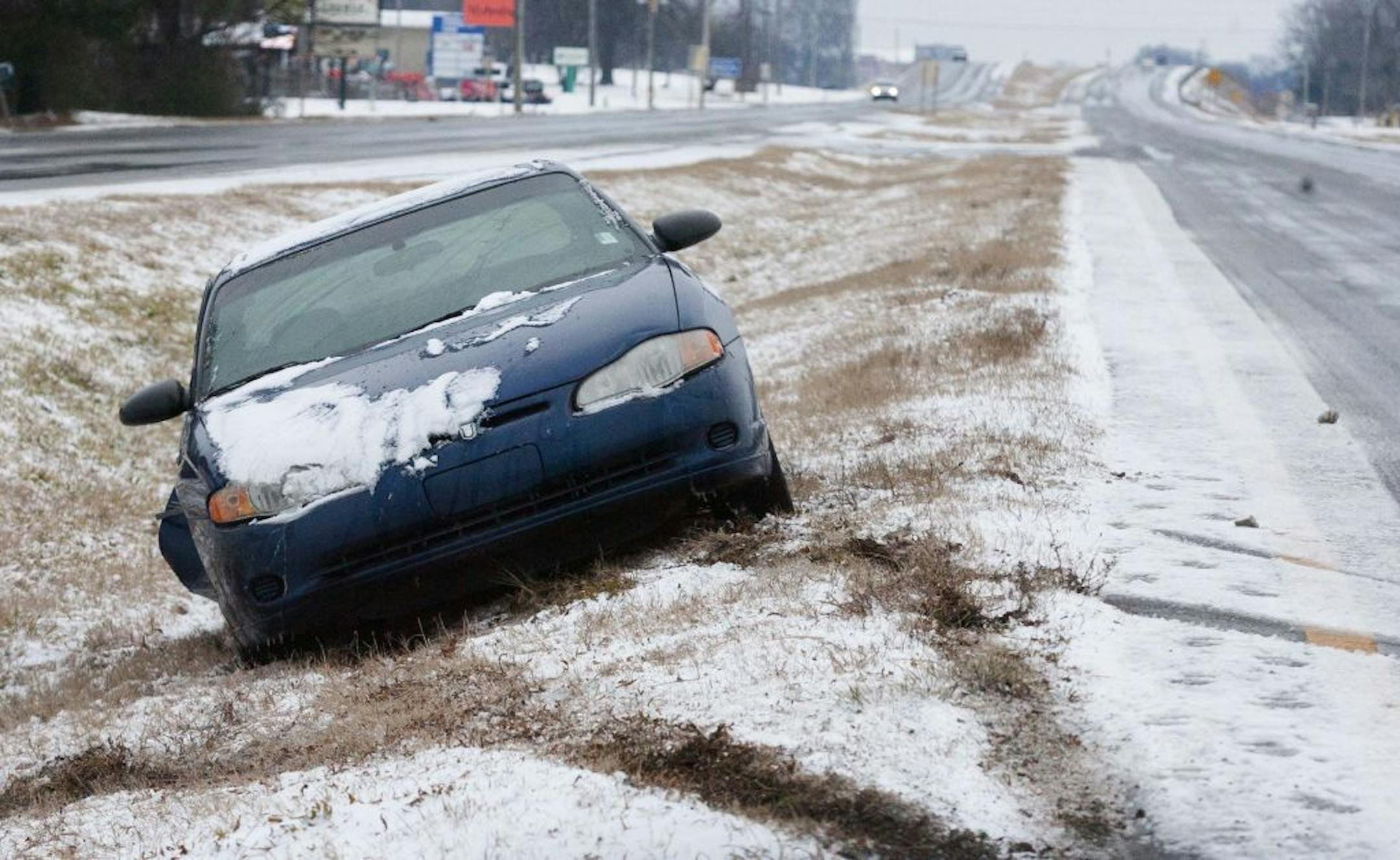A car abandoned by it's driver a car sits backwards in a ditch on highway US 20/157 near Tuscumbia, Ala., Tuesday, Feb. 11, 2014, where it slid off the ice covered road.