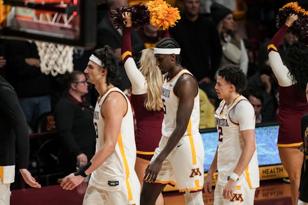 Gophers forward Dawson Garcia (3), forward Isaiah Ihnen (5), and guard Mike Mitchell Jr. (2) walked off the Williams Arena floor after the team’s 70