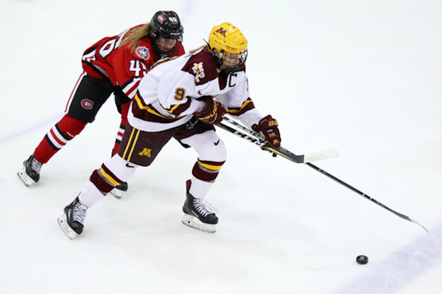 Minnesota Golden Gophers defenseman Sydney Baldwin (9) took the puck down the ice as St. Cloud State Huskies forward Aubrey Pritchett (45) raced to defend in the first period. ] ANTHONY SOUFFLE • anthony.souffle@startribune.com