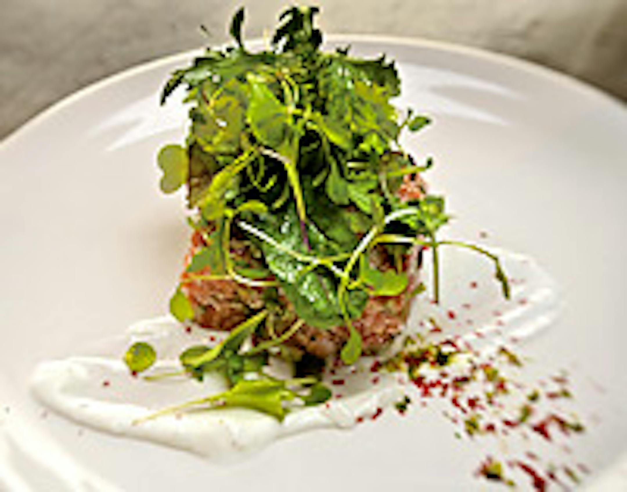 Wild salmon tartare at Corner Table in Minneapolis features Columbia River salmon, celery, pink peppercorn, pistachio and micro greens.