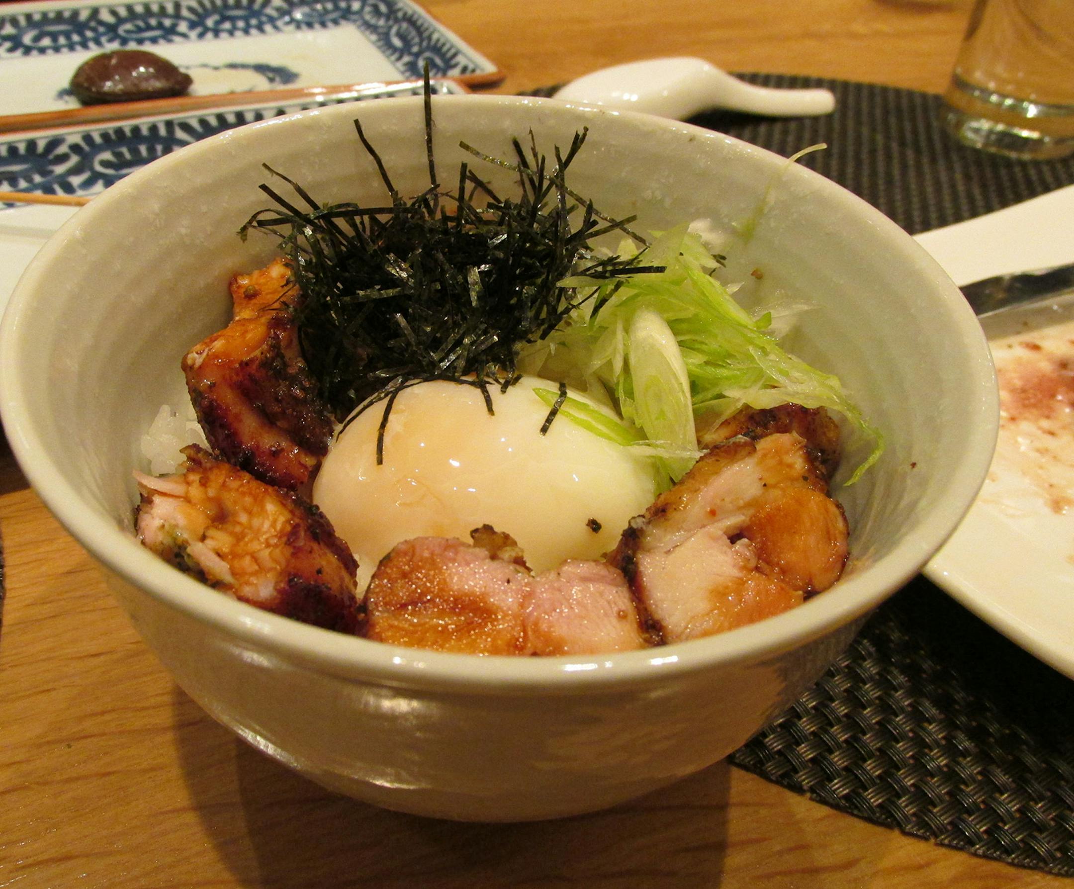 At Sumi Robata Bar, in the River North neighborhood of Chicago, the bowl of yakitori don comes with a poached egg atop slices of smoky chicken. Photo by RAPHAEL KADUSHIN/Special to the Star Tribune