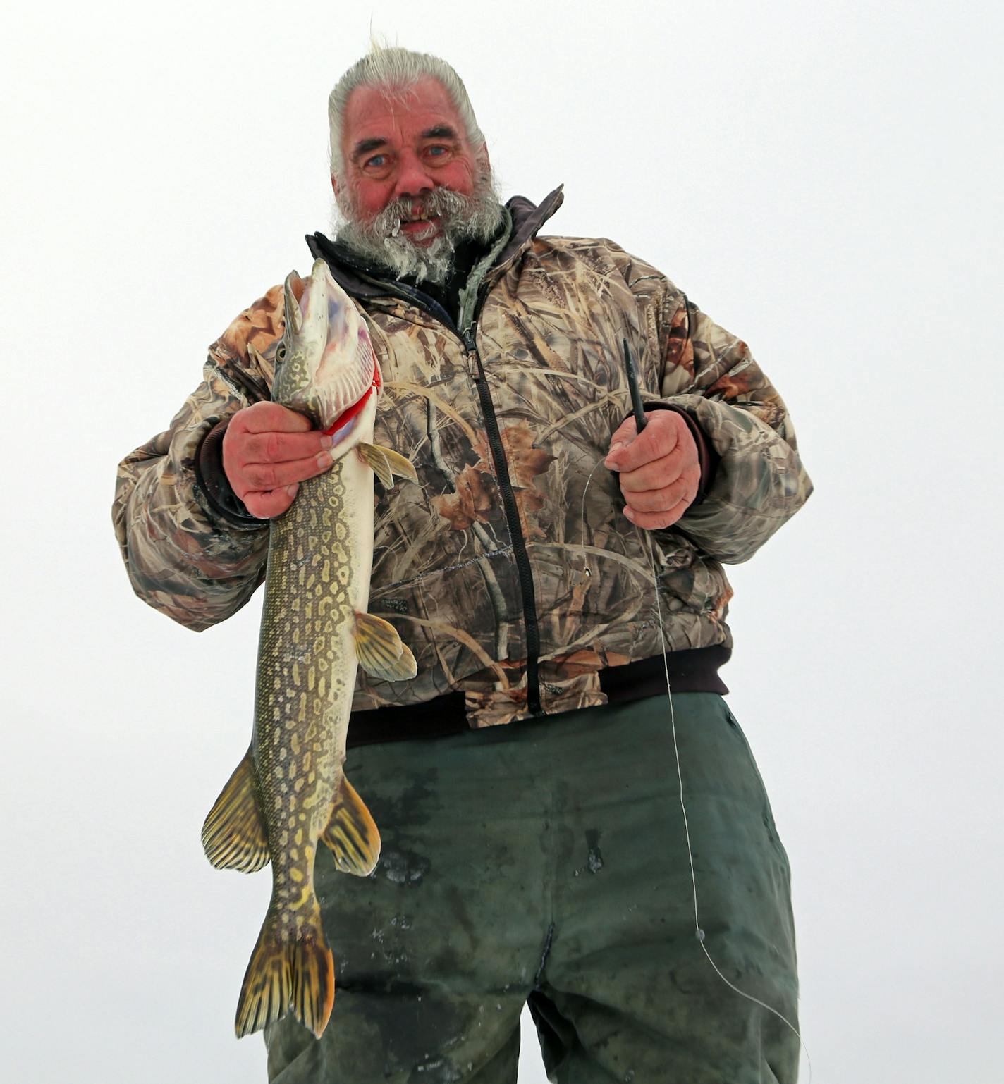 Dick "Griz'' Grzywinski of St. Paul with a northern pike taken Friday morning on a tip-up in the Chisago Lakes area. About 15 inches of ice is on parts of lakes in the Twin Cities.