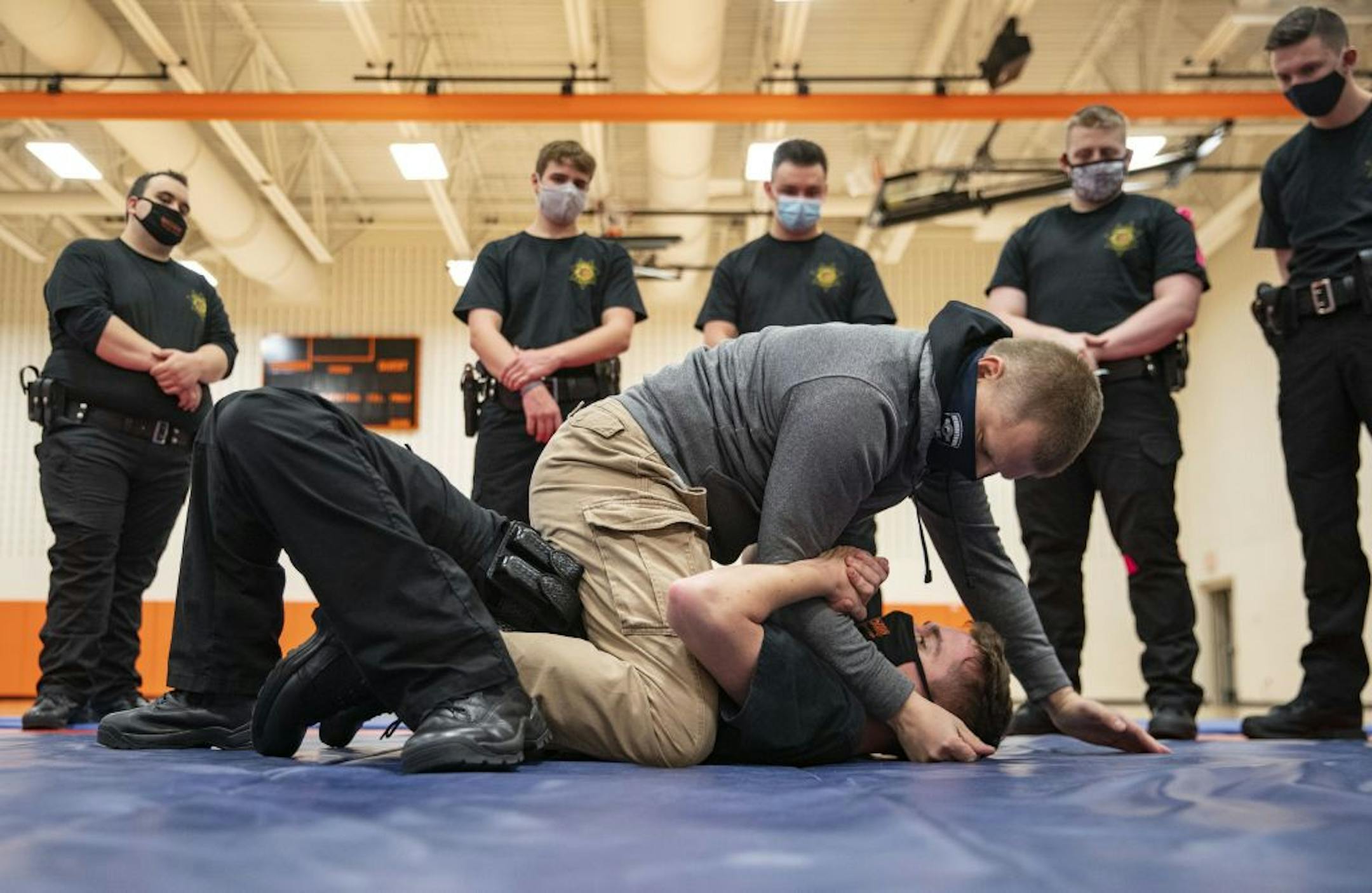 Jason Salo, a Hermantown police officer and law enforcement coordinator, demonstrated proper ground fighting technique with trainee Collin O'Toole during defensive tactics class at Fond Du Lac Tribal and Community College in Cloquet, Minn. on Tuesday November 17, 2020.