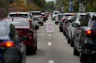 People wait in line in their cars to be tested for COVID-19 at a drive-through testing site at Zoo Miami, Monday, Jan. 3, 2022, in Miami. 