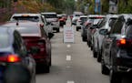 People wait in line in their cars to be tested for COVID-19 at a drive-through testing site at Zoo Miami, Monday, Jan. 3, 2022, in Miami. 