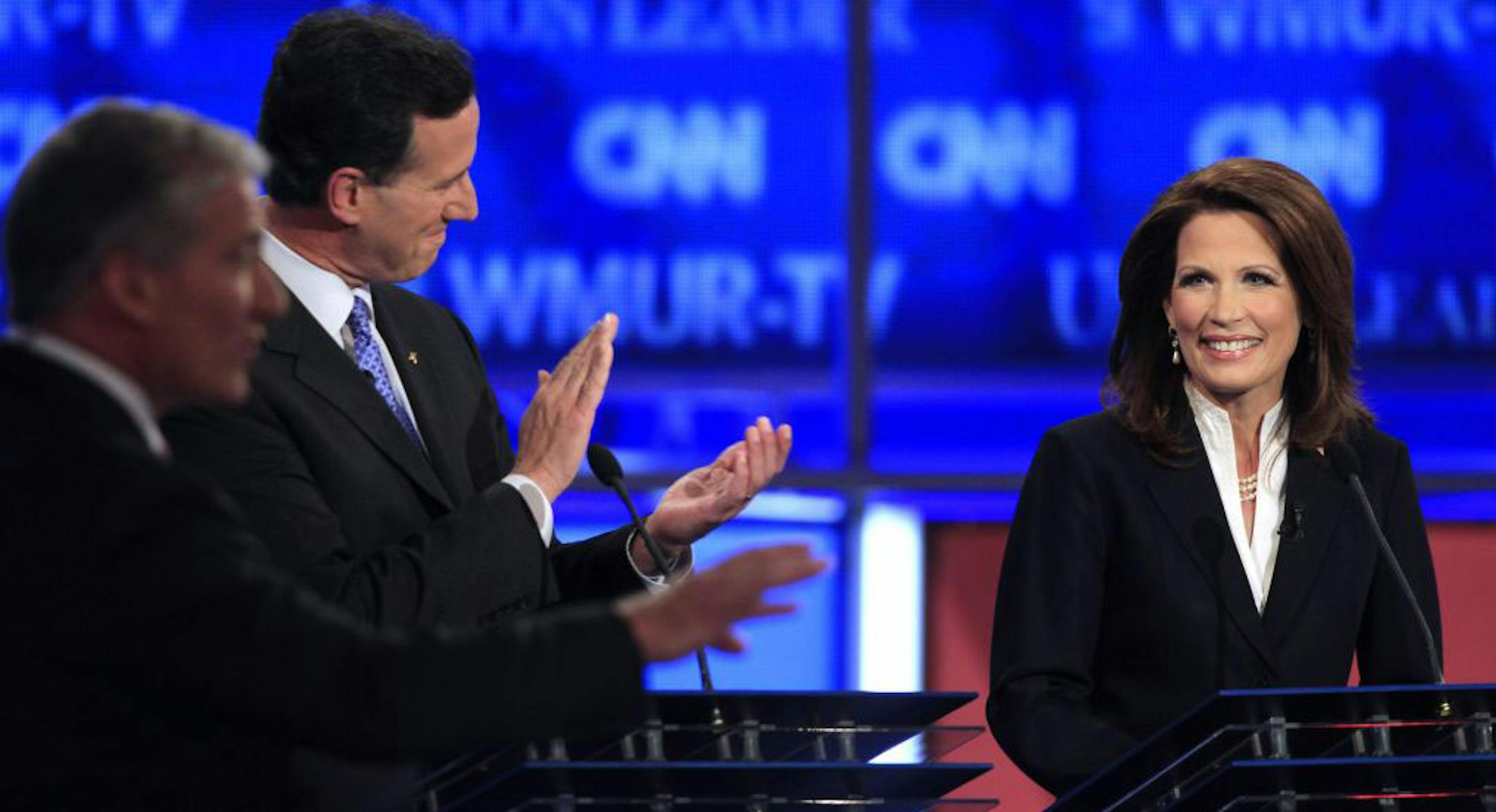 Ex-Pennsylvania Sen. Rick Santorum applauded Rep. Michele Bachmann, R-Minn., on Monday. At far left, CNN's John King.