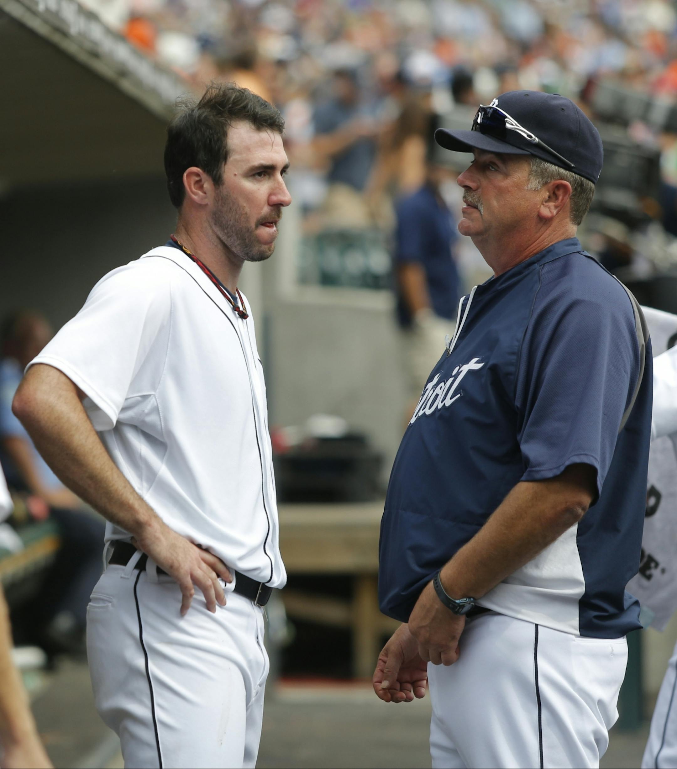 Detroit Tigers starter Justin Verlander talks with pitching coach Jeff Jones, right, after pitching the seventh inning of a baseball game against the Minnesota Twins Thursday, Aug. 22, 2013 in Detroit.