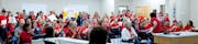 Attendees wore red shirts in support of teachers and applauded after a speaker addressed the board during a school board meeting at the Lakeville Dist