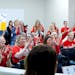 Attendees wore red shirts in support of teachers and applauded after a speaker addressed the board during a school board meeting at the Lakeville Dist