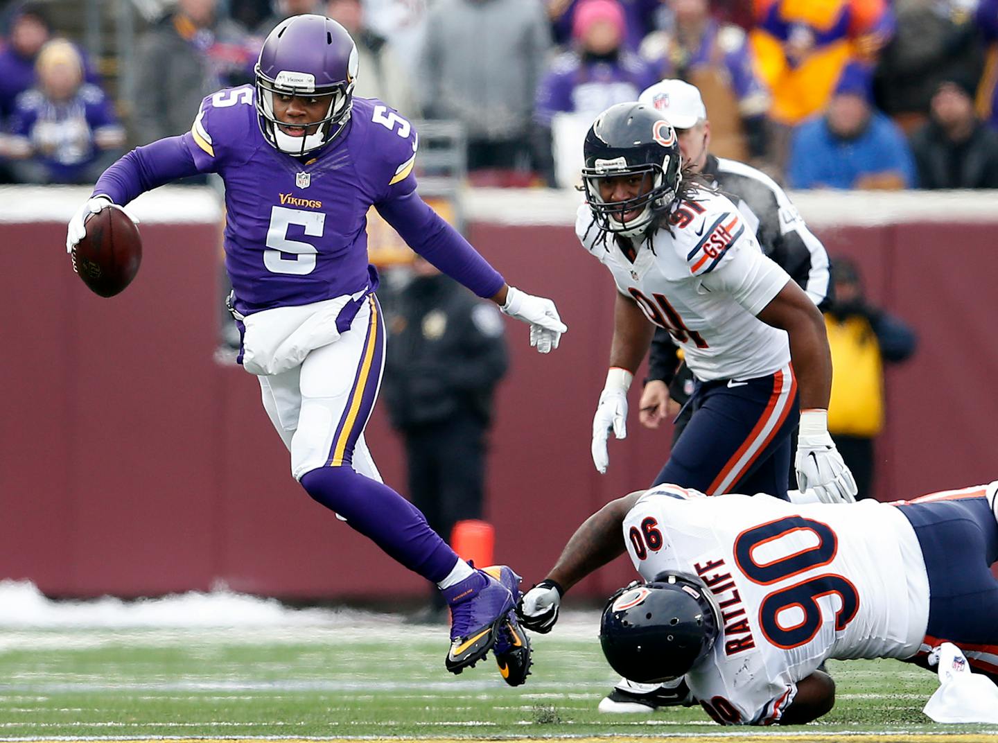 Vikings quarterback Teddy Bridgewater (5) broke a tackle by Jeremiah Ratliff (90) during a scramble in the first quarter.