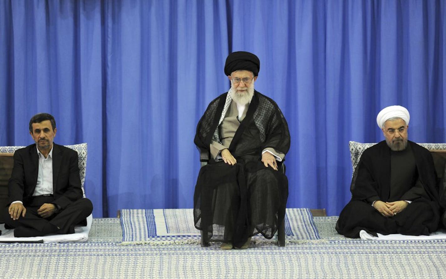 In this picture released by the official website of the Iranian supreme leader's office, Supreme Leader Ayatollah Ali Khamenei, center, President-elect Hasan Rouhani, right, and outgoing President Mahmoud Ahmadinejad, sit, in an official endorsement ceremony for Rouhani, in Tehran, Iran, Saturday, Aug. 3, 2013. Iran's supreme leader has formally endorsed Hasan Rouhani as president opening the way for the moderate cleric to take over from outgoing President Mahmoud Ahmadinejad.