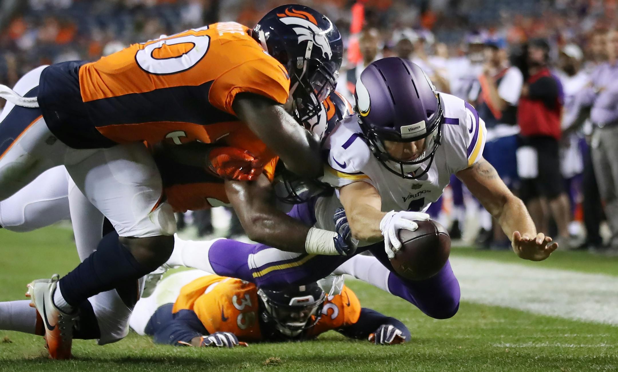 Minnesota Vikings quarterback Kyle Sloter (1) beat Denver Broncos defensive back Jordan Moore (30) to the endzone for a forth quarter score Saturday August 11, 2018 at Broncos Stadium at Mile High in Denver, CO.