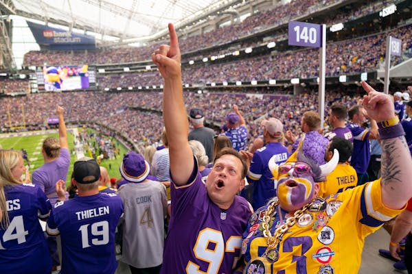 Matt Headrick, left, and TJ “Koolaid” Day celebrated after Minnesota Vikings wide receiver Justin Jefferson scored a touchdown in the first quarte