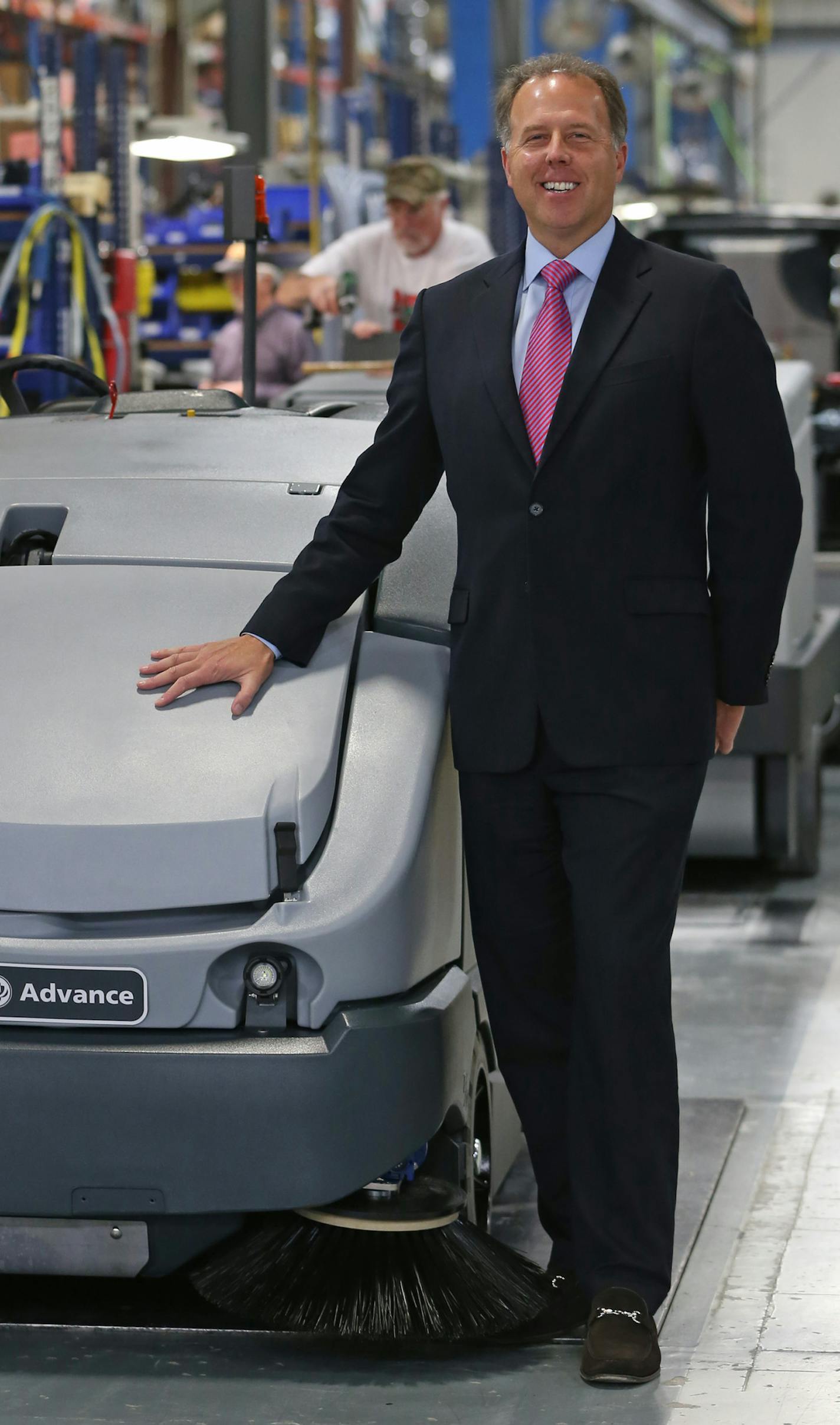 Nilfisk-Advance U.S. President Jeff Barna was photographed on 10/23/13 with an Advance CS7000 hybrid floor cleaner being built at the Plymouth MN factory. Danish company Nilfisk Advance, the low-profile competitor to Tennant in the floor-cleaning business for years, is bigger than Tennant and its U.S. operations, located just a few miles from Tennant's headquarters, has grown sales faster than the market or Tennant over the last 16 months under new leadership that arrived in 2012.] Bruce Bisping