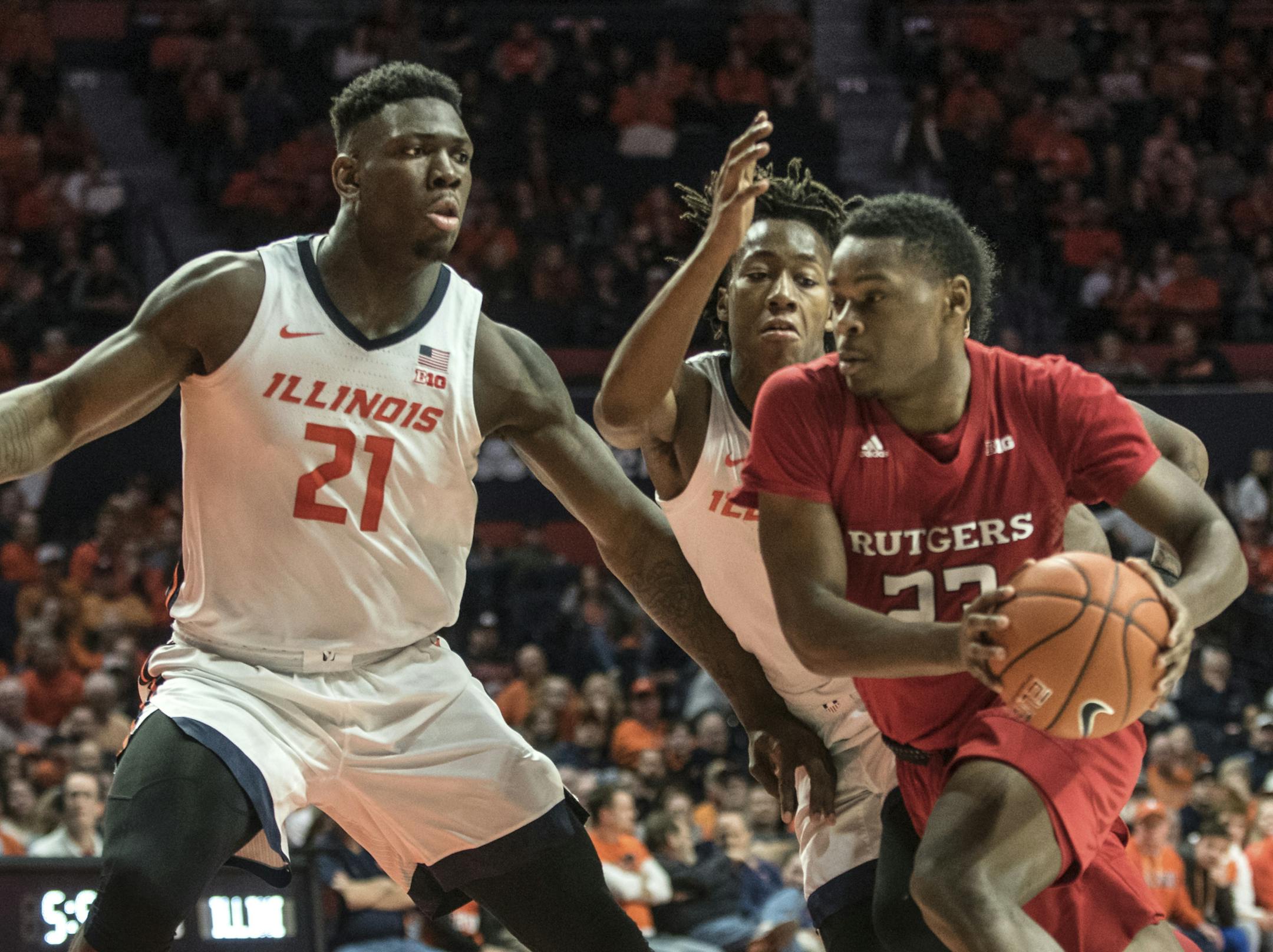 Rutgers' Montez Mathis (23) drives to the basket as Illinois' Kofi Cockburn (21) and Ayo Dosunmu (11) defend in the second half of an NCAA college basketball game, Sunday, Jan. 11, 2020, in Champaign, Ill. (AP Photo/Holly Hart)