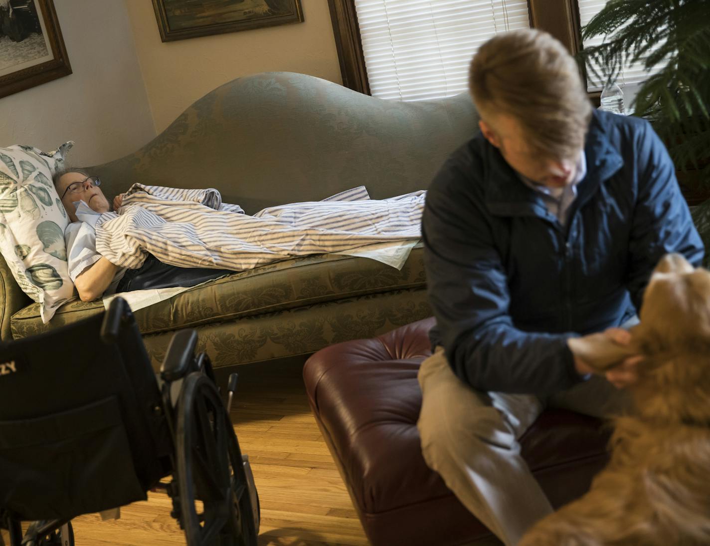 Christian Fritzberg played with his mom's dog after he situated his mother Barbara Fritzberg for a nap on the couch on March 3, 2017 in Minneapolis, Minn. ] RENEE JONES SCHNEIDER &#x2022; renee.jones@startribune.com