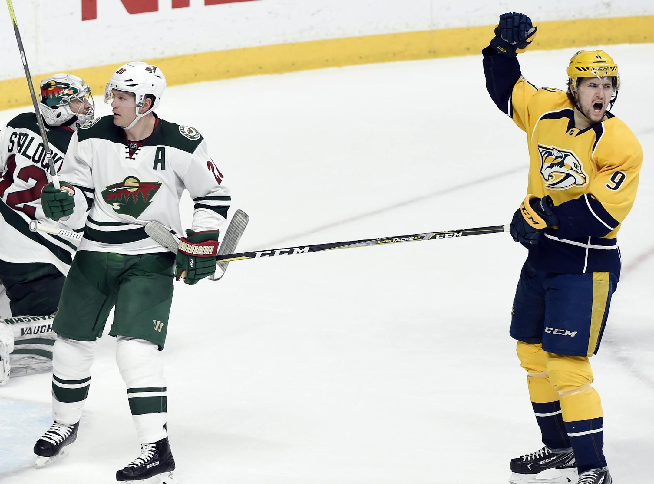 Nashville Predators left wing Filip Forsberg (9), of Sweden, celebrates after scoring a goal against Minnesota Wild goalie Alex Stalock (32) and defenseman Ryan Suter (20) during the second period of an NHL hockey game Saturday, April 1, 2017, in Nashville, Tenn. (AP Photo/Mark Zaleski)
