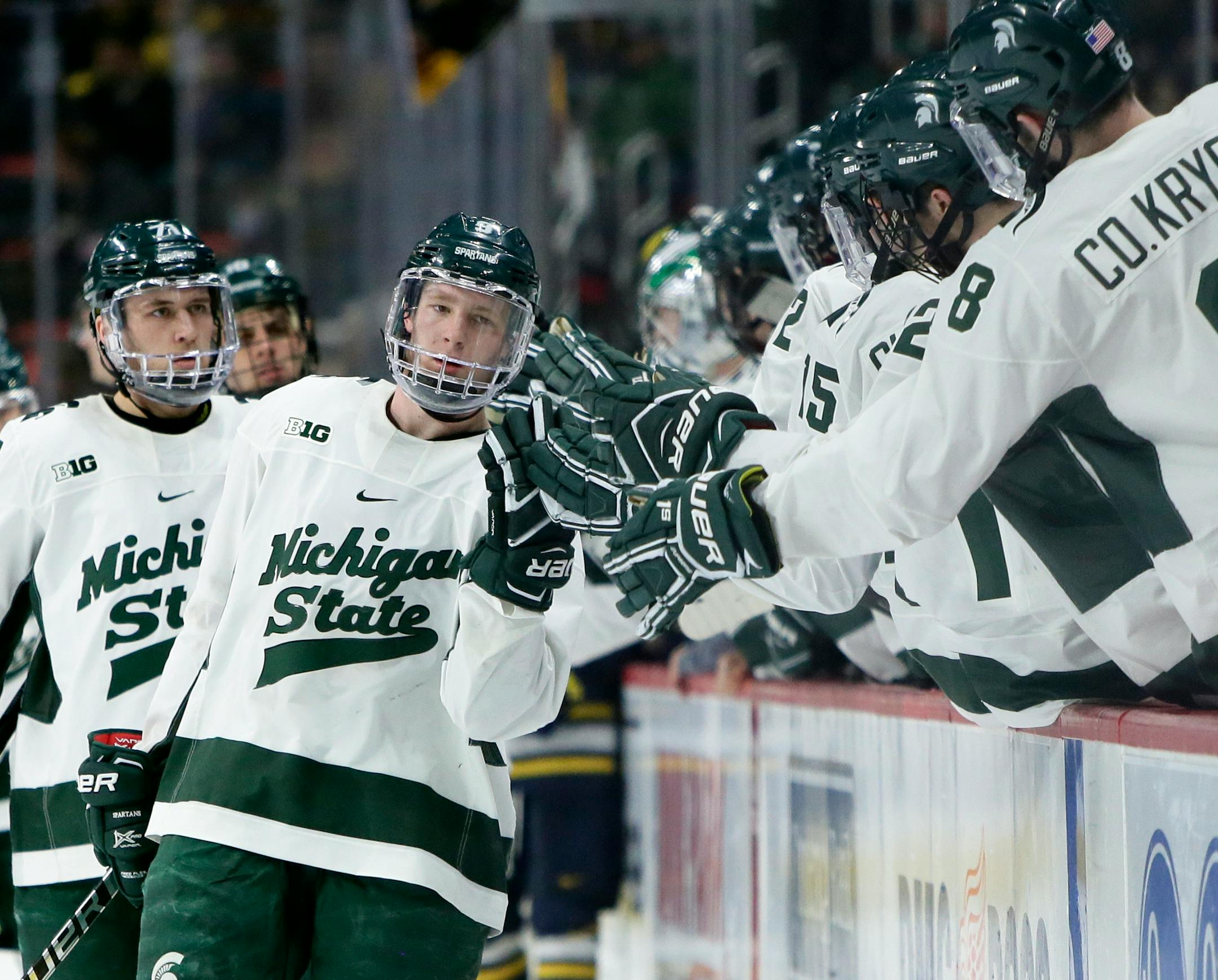 Michigan State forward Mitchell Lewandowski celebrates with teammates after scoring against Michigan during the third period of an NCAA college hockey game, Saturday, Feb. 9, 2019, in Detroit. Michigan defeated Michigan State 5-2. (AP Photo/Duane Burleson)